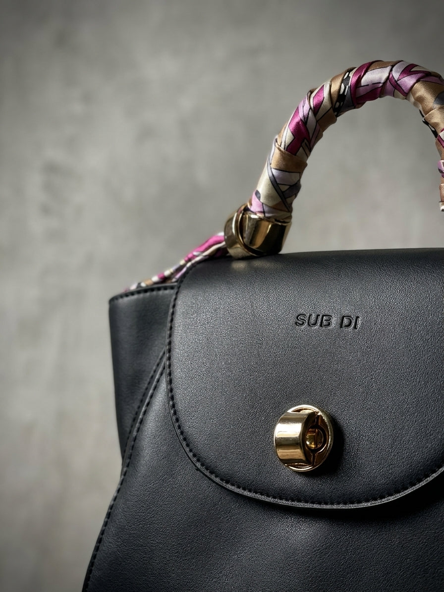 Black Chic Handbag with Scarf-Wrapped Handle and Gold Hardware
